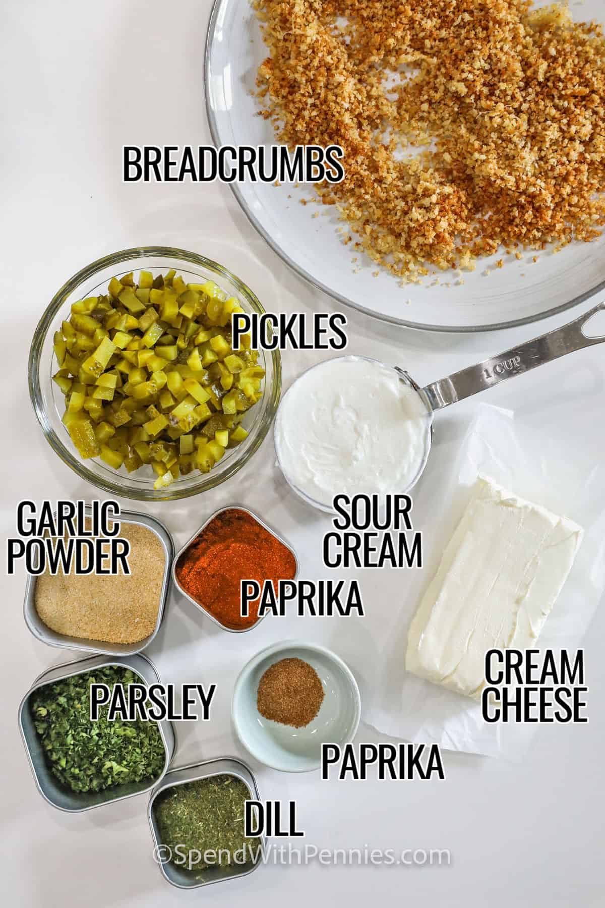 Deep-fried pickles from the county fair get a tasty makeover as fried pickle dip! Blended with cream cheese, sour cream, diced pickles, savory spices, and crispy parmesan breadcrumbs, this dip is crunchy and tangy. Customize it with ranch or buffalo flavors. This easy recipe uses pantry ingredients for an irresistible southern treat. #spendwithpennies breadcrumbs , pickles , sour cream , paprika , garlic powder , parsley , dill , cream cheese with labelst to make Fried Pickle Dip