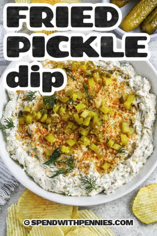 Deep-fried pickles from the county fair get a tasty makeover as fried pickle dip! Blended with cream cheese, sour cream, diced pickles, savory spices, and crispy parmesan breadcrumbs, this dip is crunchy and tangy. Customize it with ranch or buffalo flavors. This easy recipe uses pantry ingredients for an irresistible southern treat. #spendwithpennies plated Fried Pickle Dip with chips around it and a title