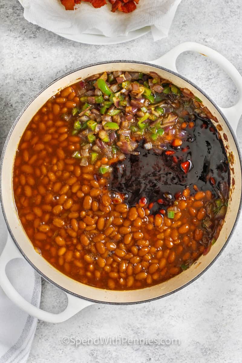 adding ingredients together to make The Best Baked Beans