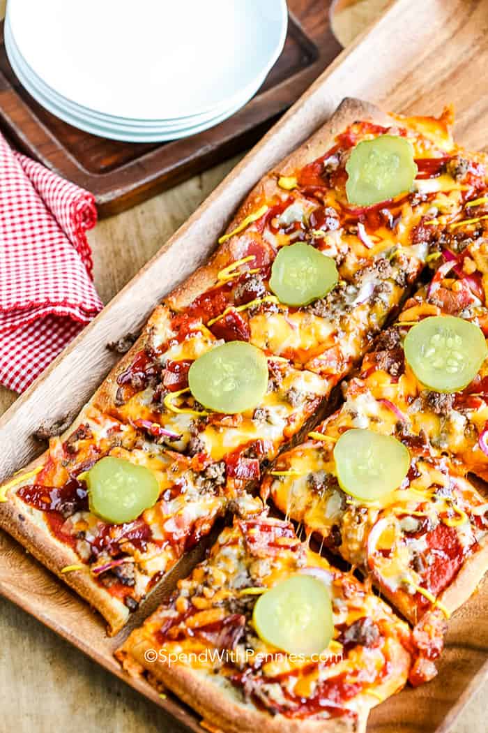 overhead of Cheeseburger Pizza topped with pickles cut into pieces