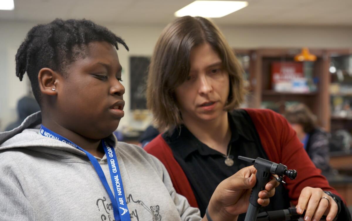 High school freshman DeWayne Murphy consults with Milks, his science teacher, on a classroom experiment.