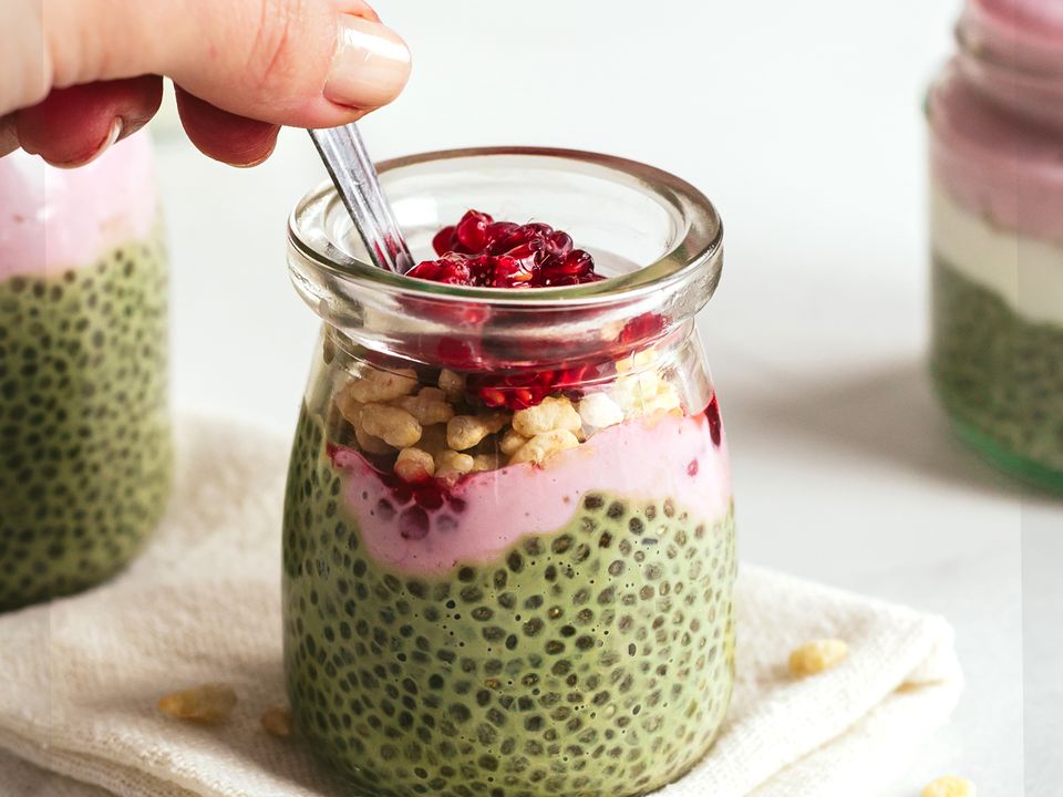 hand stirring matcha chia pudding with raspberries in a pot 38206ccace313c252914a8f44bc87b19 960 q60